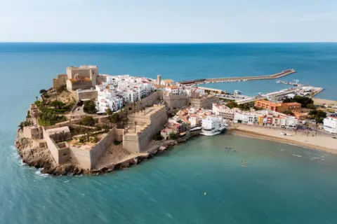 Vista aérea del castillo y el casco antiguo de Peñíscola, con la playa norte y el mar Mediterráneo.