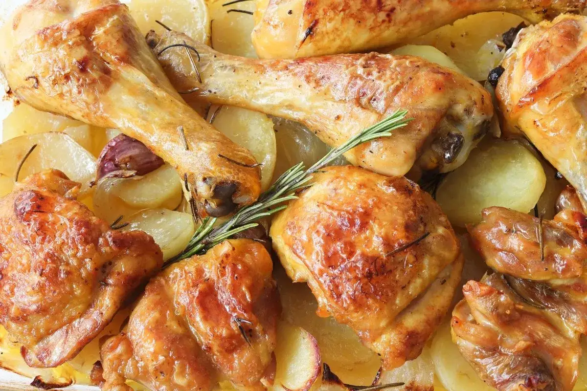 Contramuslos de pollo dorados y jugosos, asados con patatas, ajo y romero. Un plato casero irresistible.